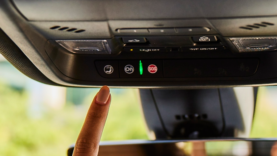 hand about to press the Onstar button